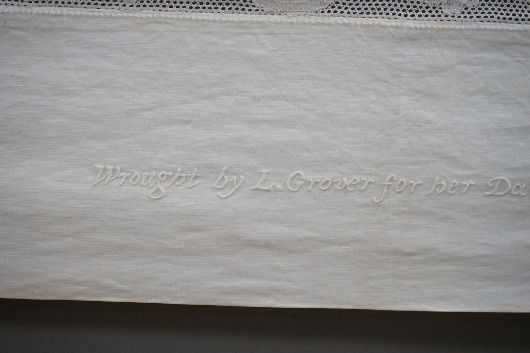 An unusual Victorian white linen hand worked table cloth. Embroidered along one edge, Wrought by L. Grover for her daughter Ethel Frances Burbury 1895. Together with three crochet edged cloths and a circular embroidered